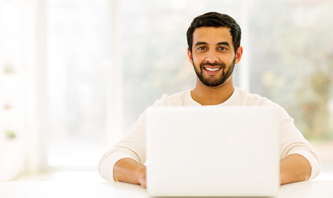 student using laptop at home